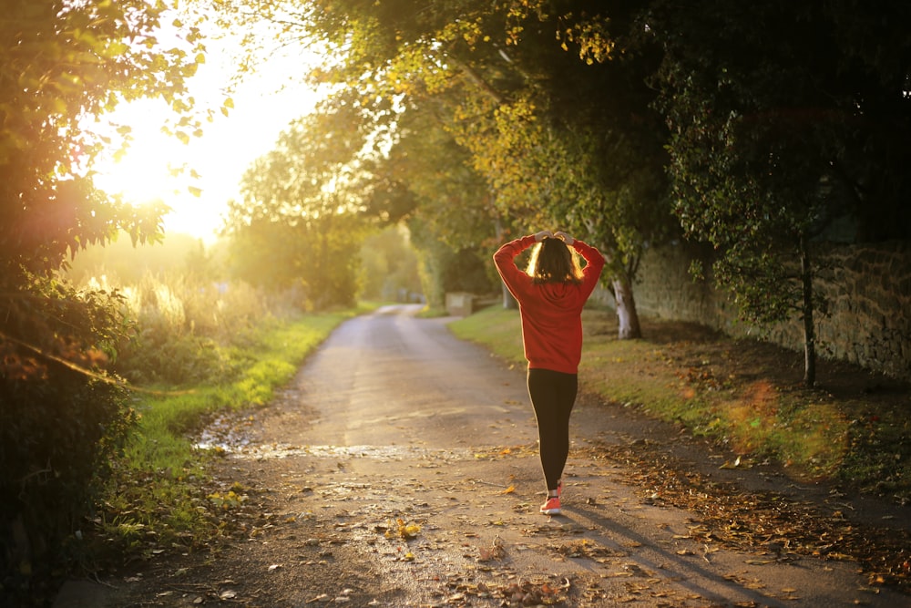 Woman walking a sunlit path at golden hour